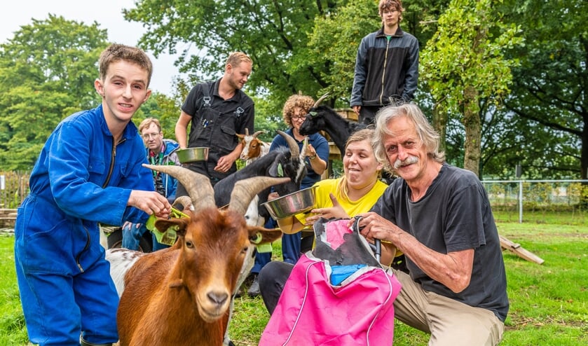 Vrijwilliger Toon Hesp te midden van de beheerder en de cliënten van Reinaerde. Deze geit wilde overigens wel heel graag op de kiek en liep iedereen welhaast omver!