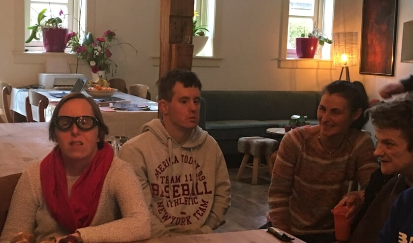 De bewoners kunnen helpen bij het klaarmaken van de maaltijden. Adri laat de speciale uienbril zien.