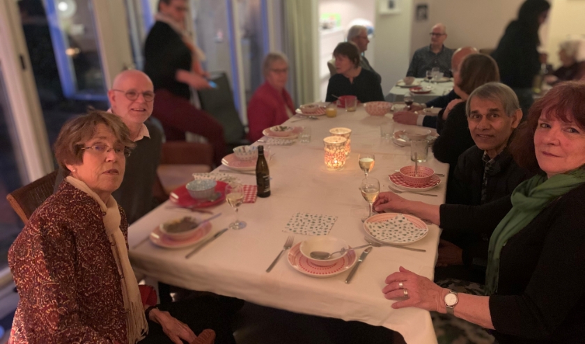 20 vrijwilligers genieten van het eten en de prima sfeer.