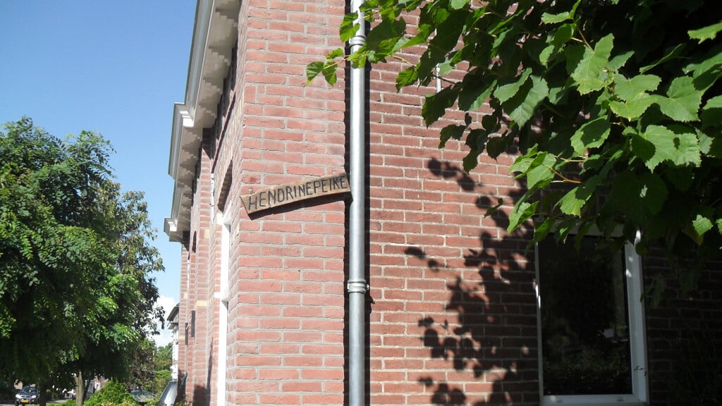 Op de hoek van het Mariapad aan de zijgevel van Van Vroonhovenlaan 40 hangt een houten straatnaambordje met de naam Hendrinepeike. FOTO: Erfgoedhuis Veldhoven.