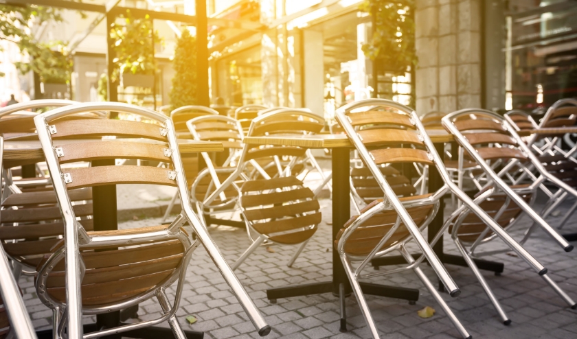 Closed outdoors cafe with overturned chairs on tables, Nobody