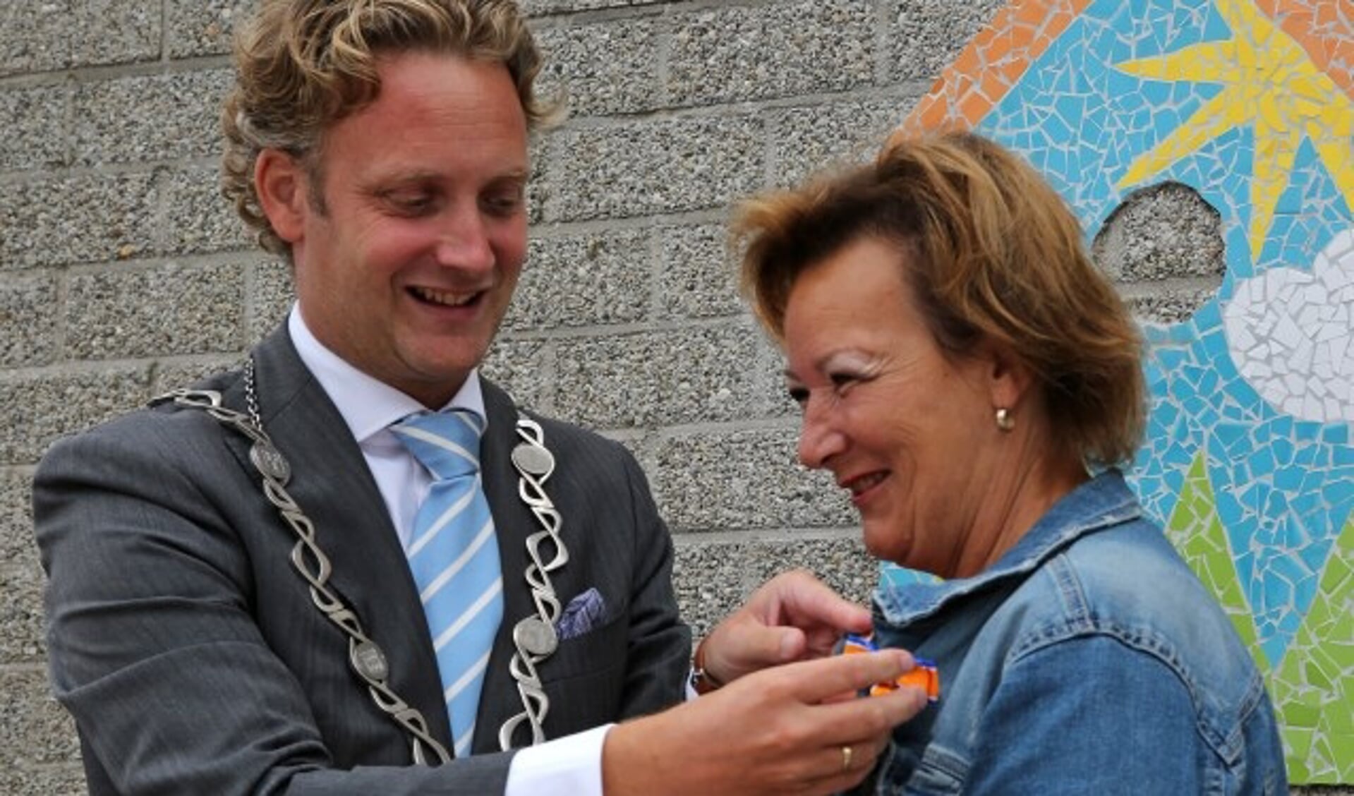 Marjola Vreeswijk-Kastelein ontvangt de koninklijke onderscheiding van burgemeester Pieter Verhoeve. (Foto: Alex de Kuijper)