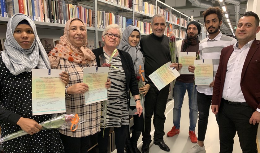 • Enkele 'nieuwe Nederlanders' en de twee wethouders.