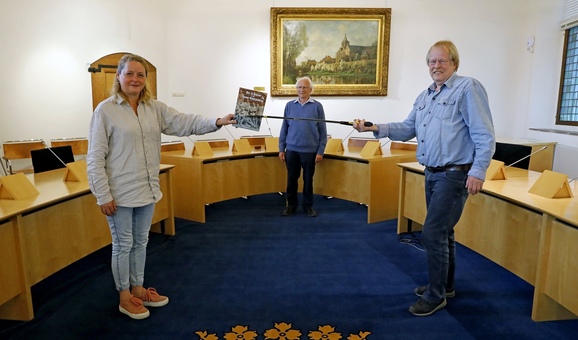 • De overhandiging van het boek, met v.l.n.r. wethouder Christa Hendriksen, Walter van Zijderveld (op de achtergrond) en Ronnie Hendriks.