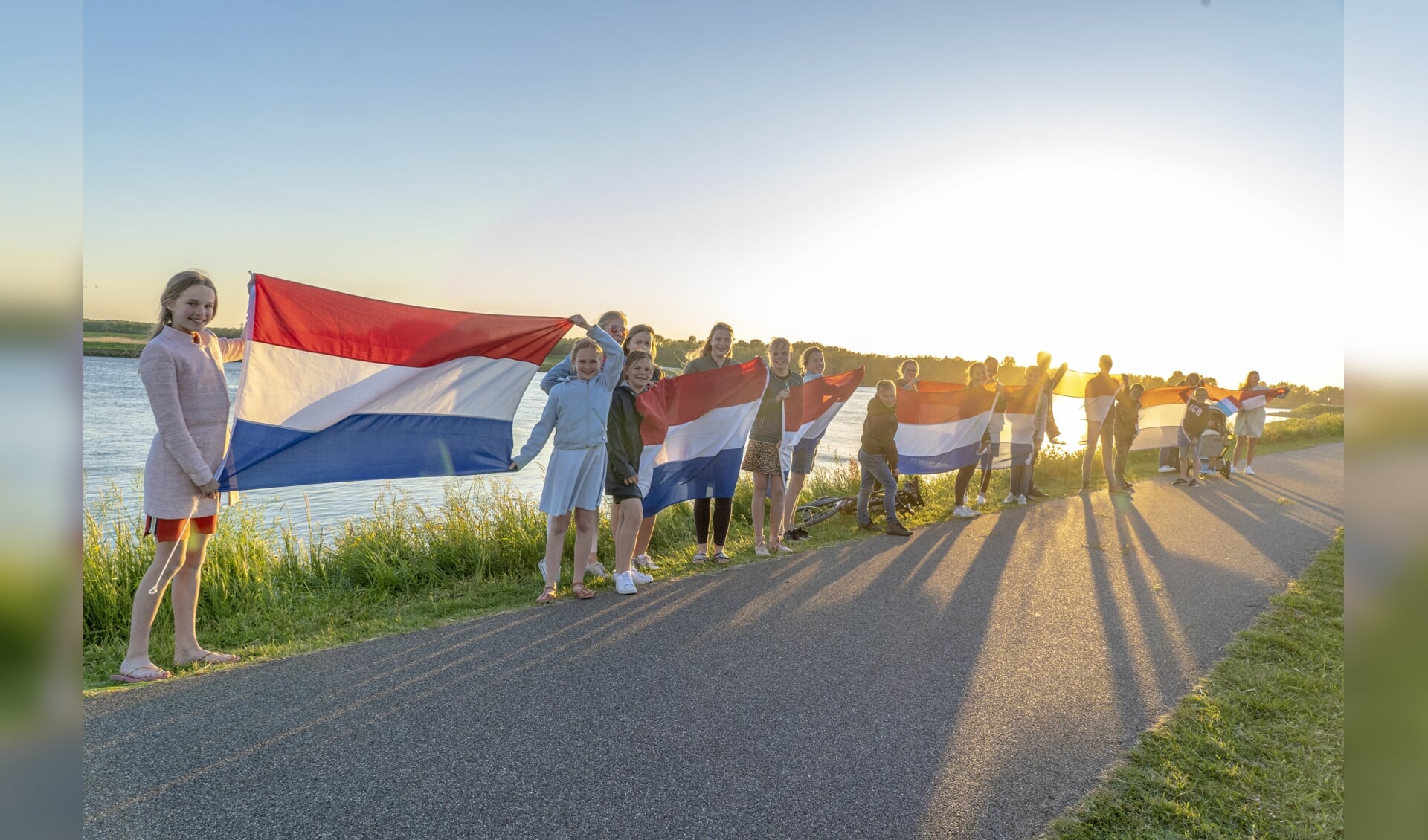 • Overal langs de dijk zwaaiden mensen met vlaggen om Bevrijdingsdag te vieren.