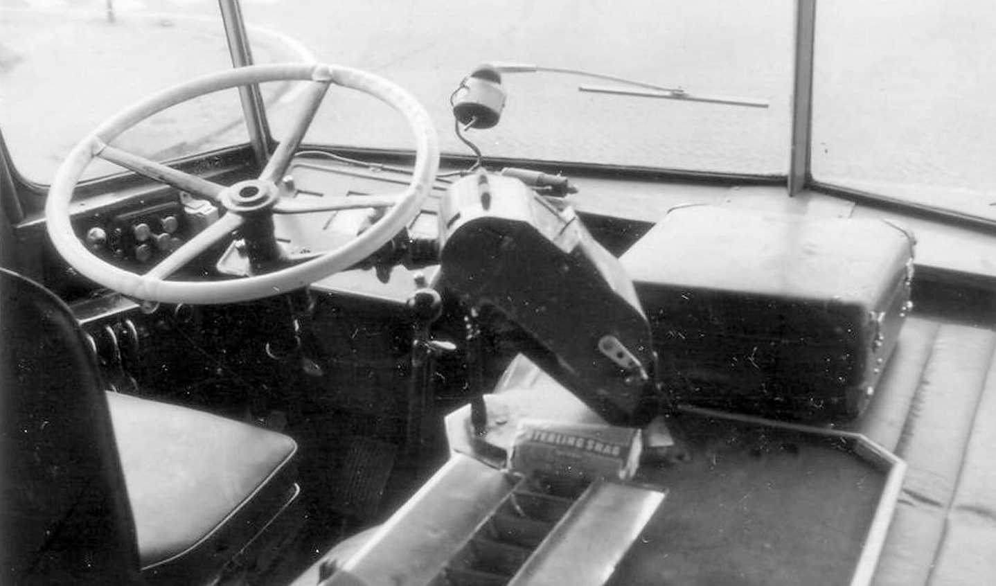 De zitplaats van de bestuurder met het forse houten stuur. Geen mondkapjes aan boord maar wel een pakje Sterling shag van de chauffeur onder de kaartjesautomaat.