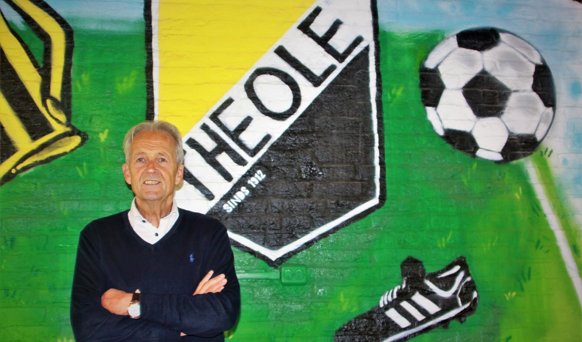 De voorzitter van Theole, Joan van den Heuvel, bij de muurschildering in de kantine van 'zijn' club.