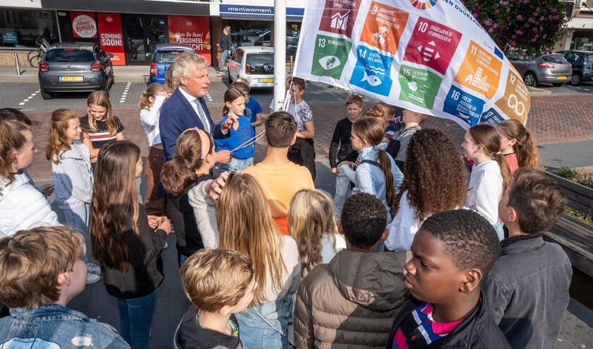 <p>Wethouder Wubbo Tempel hijst de vlag samen met de kinderen. </p>