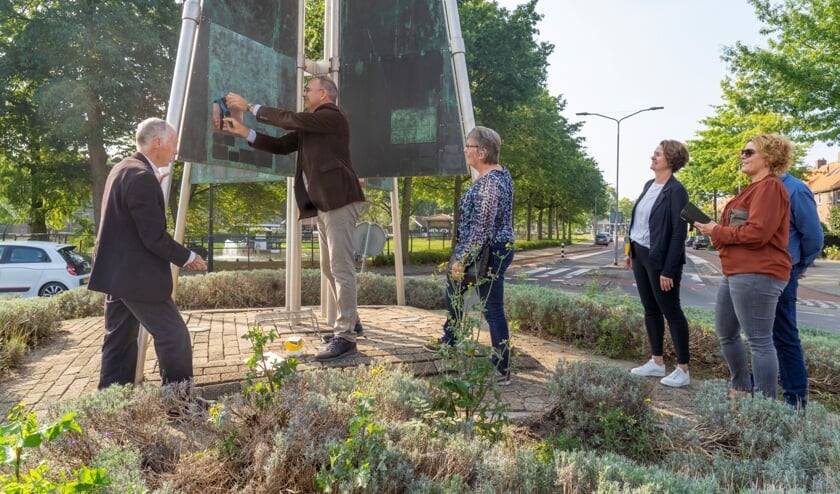 • Burgemeester Paans hangt een van de plaquettes op.