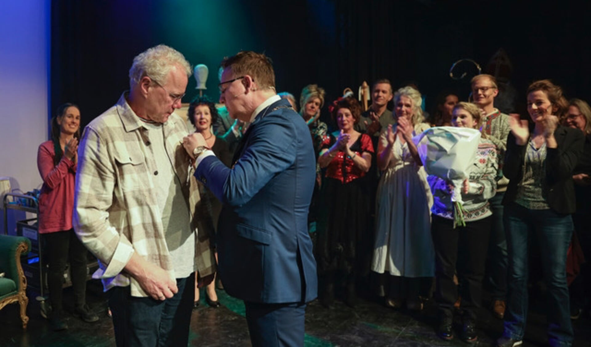 • Piet de Bruin krijgt het lintje opgespeld door burgemeester Van Domburg.
