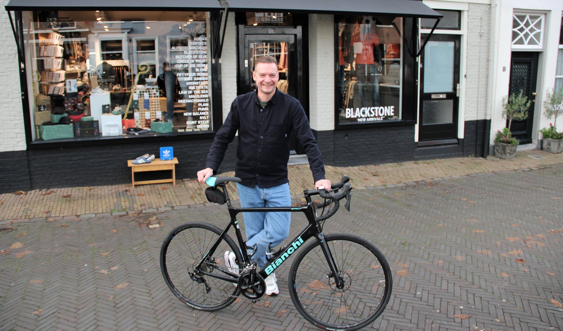 • Marcel Teeuwen met zijn racefiets voor kledingwinkel Streakers in Schoonhoven.