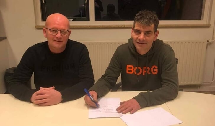 • Wynoud Slegtenhorst (r) zet zijn handtekening onder de contractverlenging.