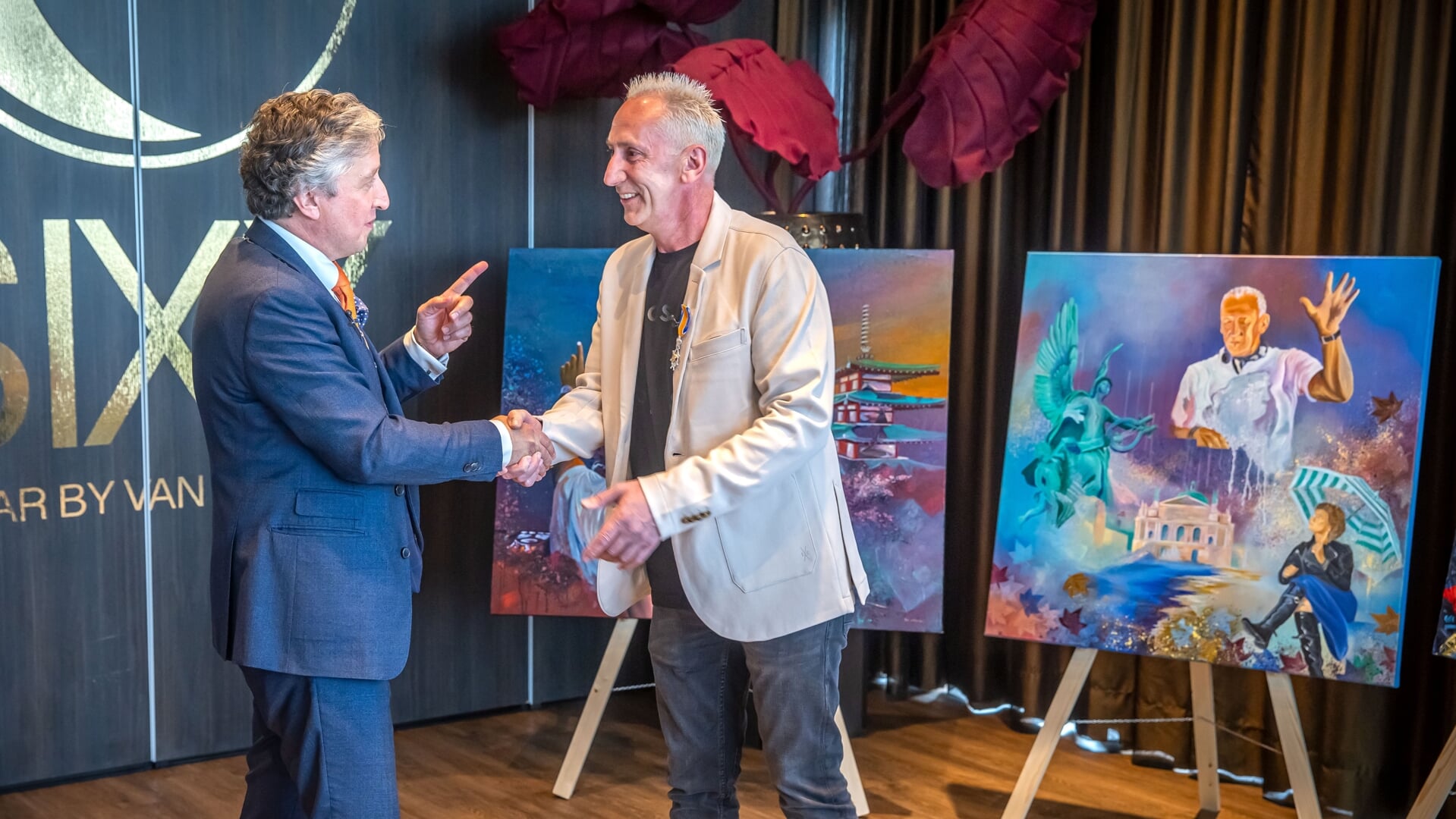 • Johan Gielen wordt gefeliciteerd door burgemeester Hans Beenakker, die hem de Koninklijke Onderscheiding opspeldde.