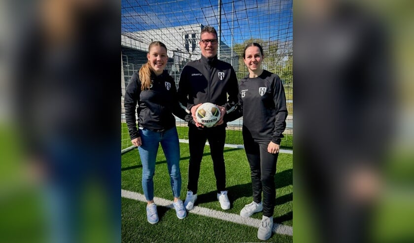 • Trainer Vendelbosch met speelsters Anna en Sanne.