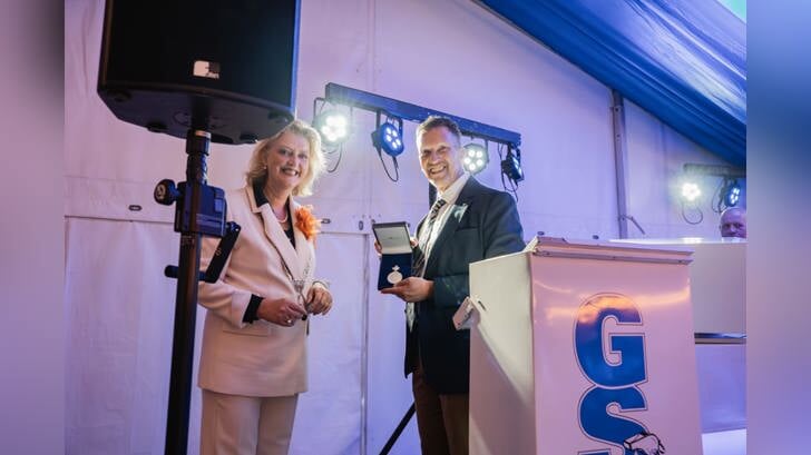 • GSV-voorzitter Ron Collé ontvangt de Erepenning van Reinie Melissant. 
