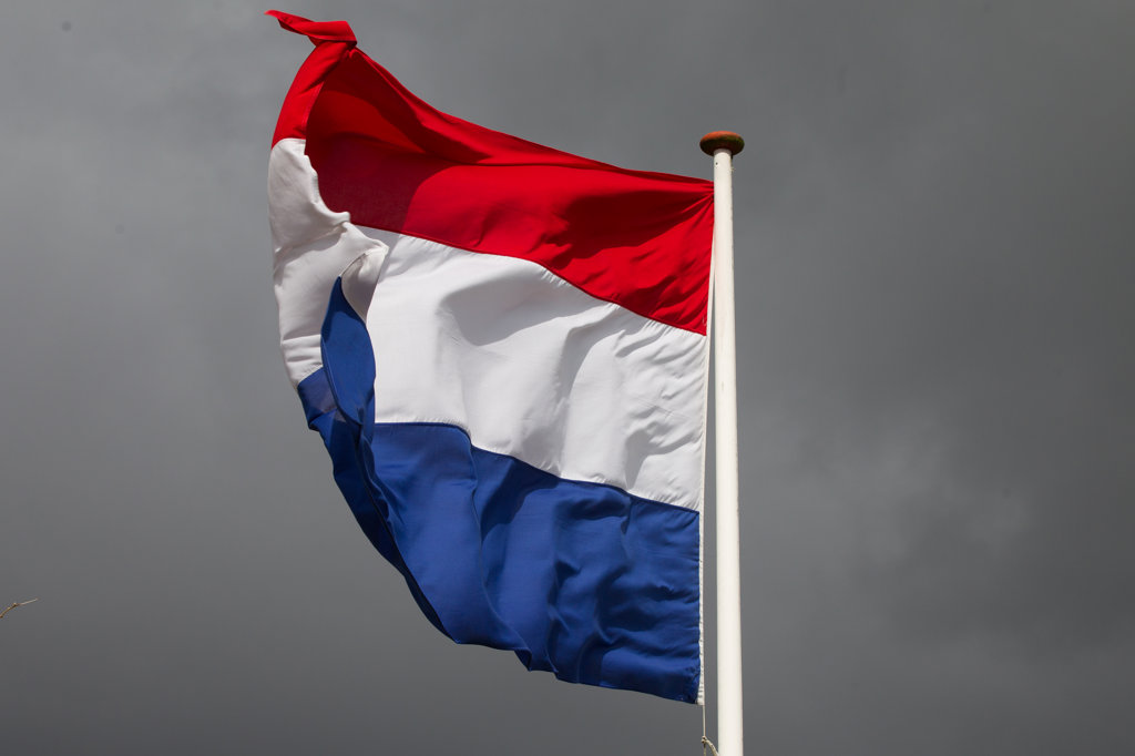 wapperende vlag met grijze bewolking, Leerdam foto Wim de Bruijne