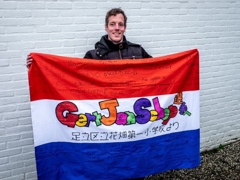 • Een trotse Gert-Jan Schep met een supportersvlag vanuit Japan.