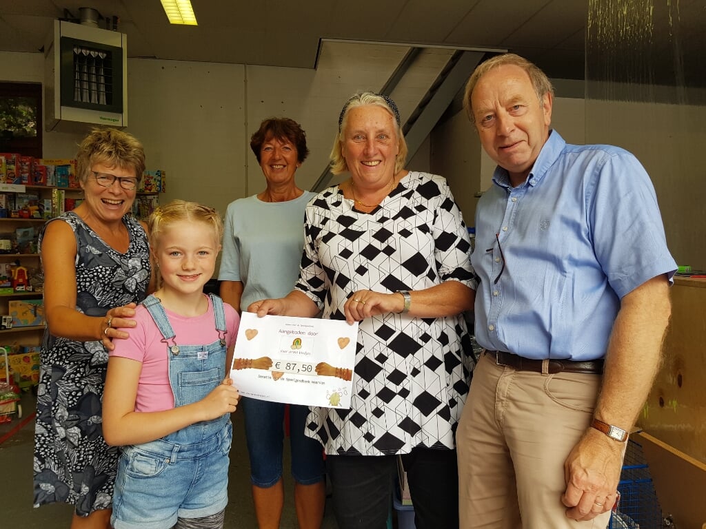 • June ging zaterdag langs bij de speelgoedbank in Woerden om een zelfgemaakte cheque te overhandigen. 