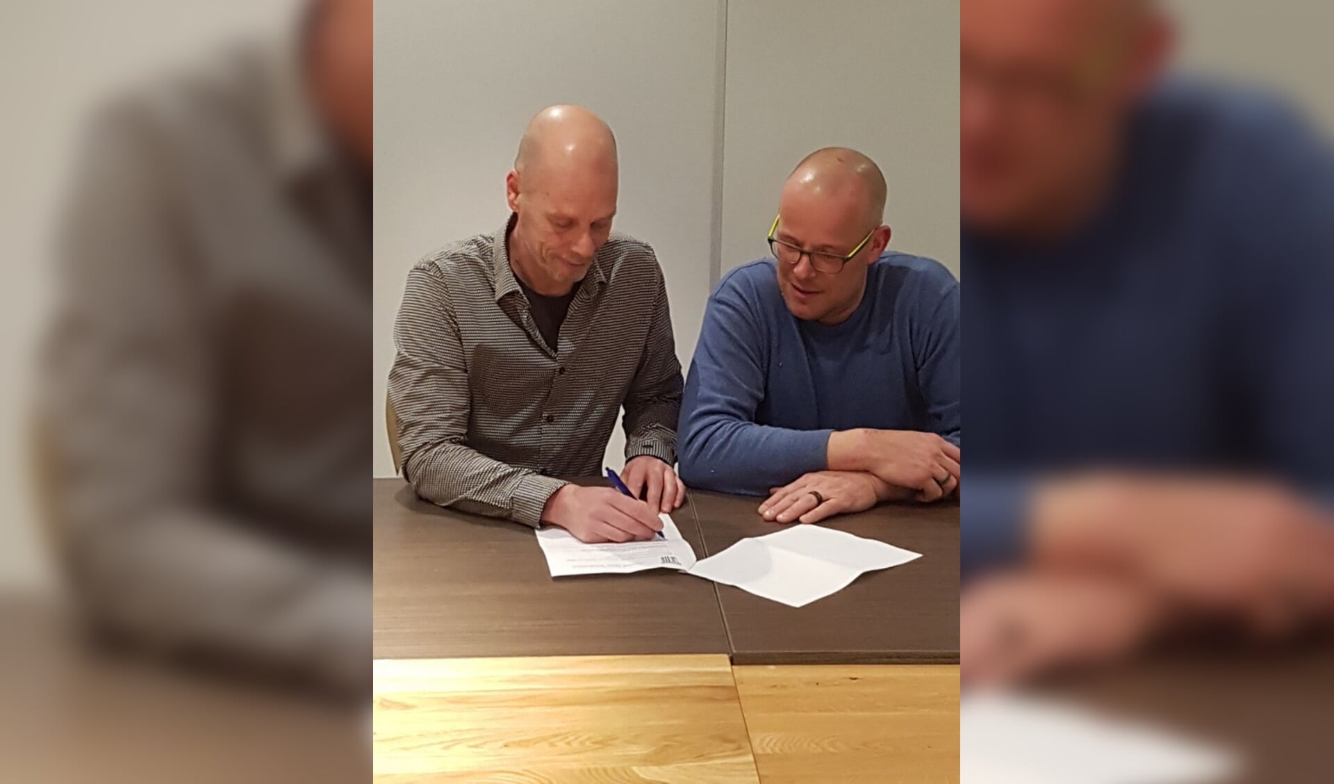  Jan van er Kolk tekent contract. Rechts voorzitter Van Tilburg.