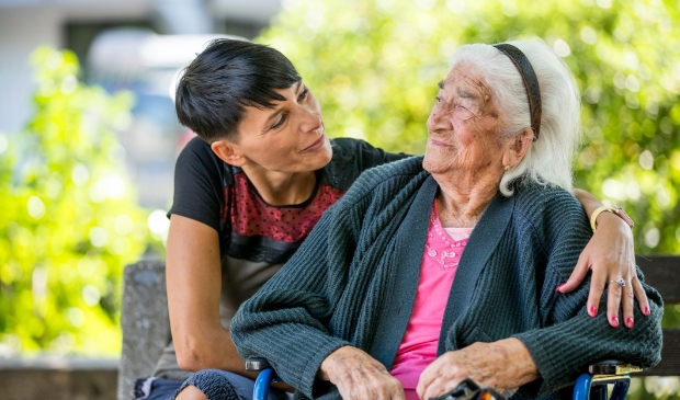 Volunteer Woman Visiting Senior Woman In The Nursing Home 