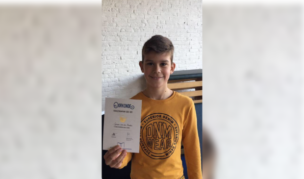 Gerson van der Maaten ontvangt de oorkonde n.a.v. de voorleeskampioenschappen op de Koldewijn Schoele uit Kamperveen