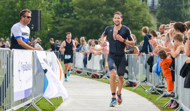 Han-Peter Lucas in actie tijdens Triathlon Zwolle. Links zijn trainer Lars Karmelk.