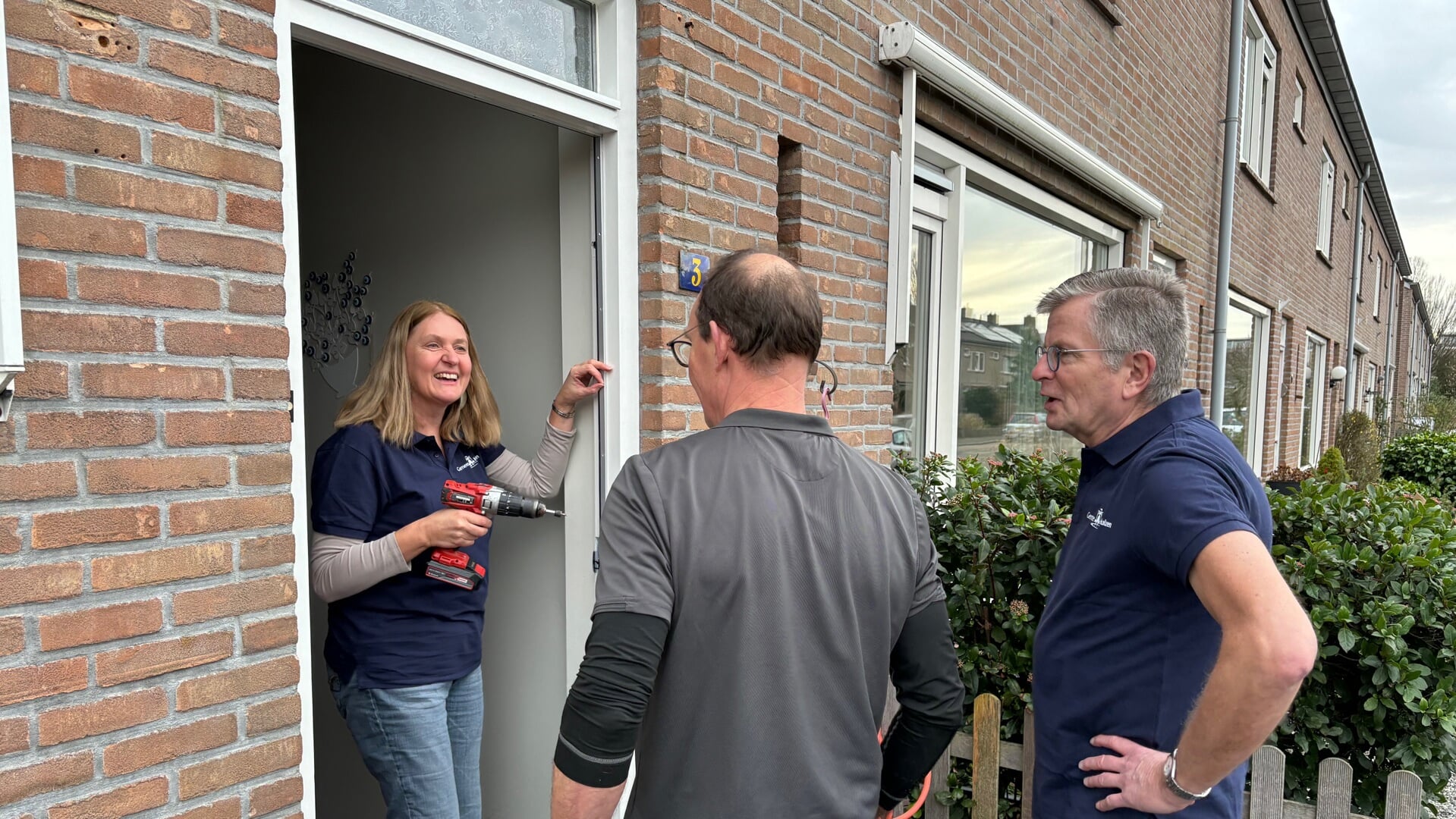 Wethouders Bert Rebel en Karin van Werven brengen samen met Ronald Smout van de Fixbrigade kierdichting aan bij de voordeur. (Foto Bob Awick Fotografie) 