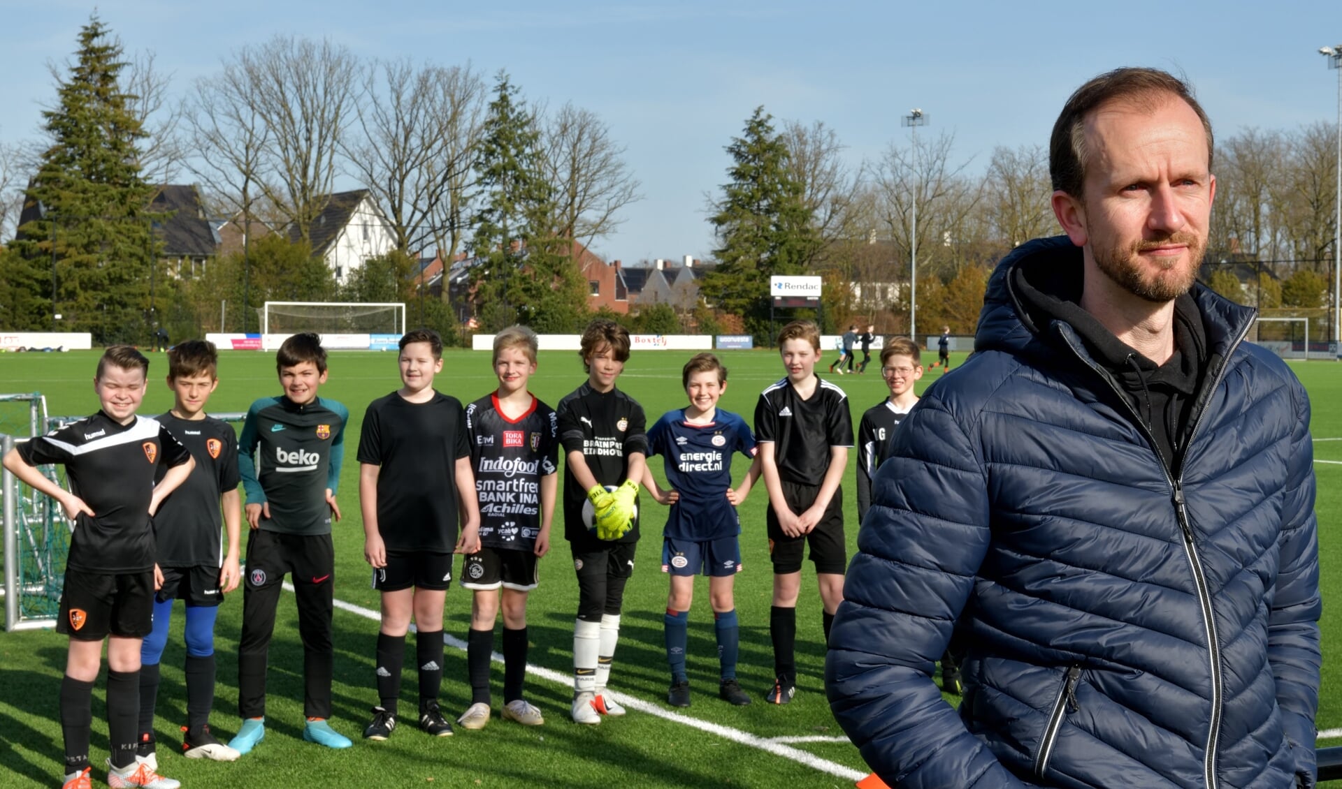 Marko op het veld bij SBC met op de achtergrond SBC-jeugdleden