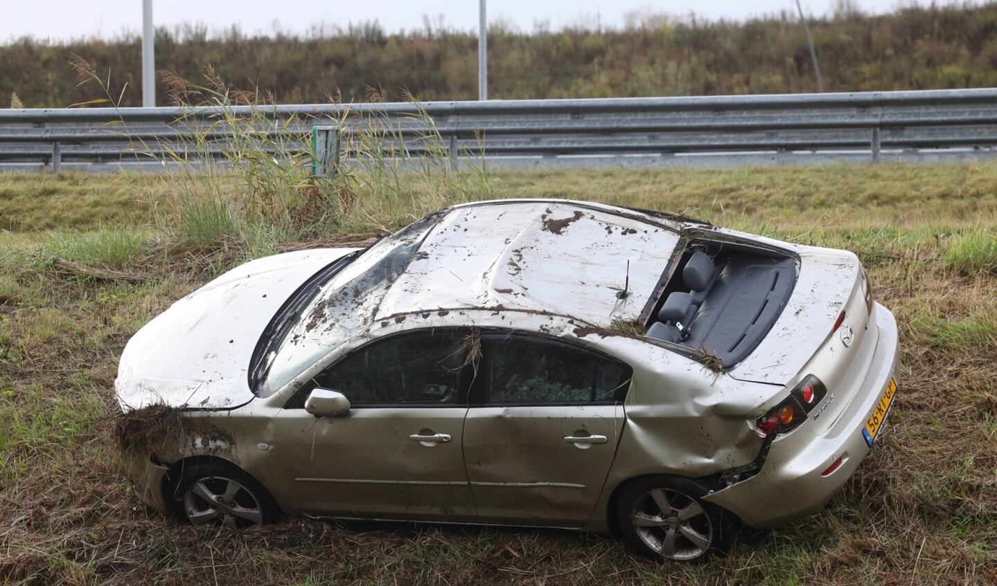 Auto op zijn kop in greppel langs snelweg A50 bij Son en Breugel