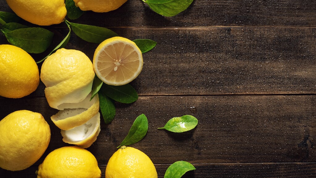 Top View Fresh Yellow Lemon Fruits with Leaves on Wet Wood Table Background with Copy Space - Still Life Photography
