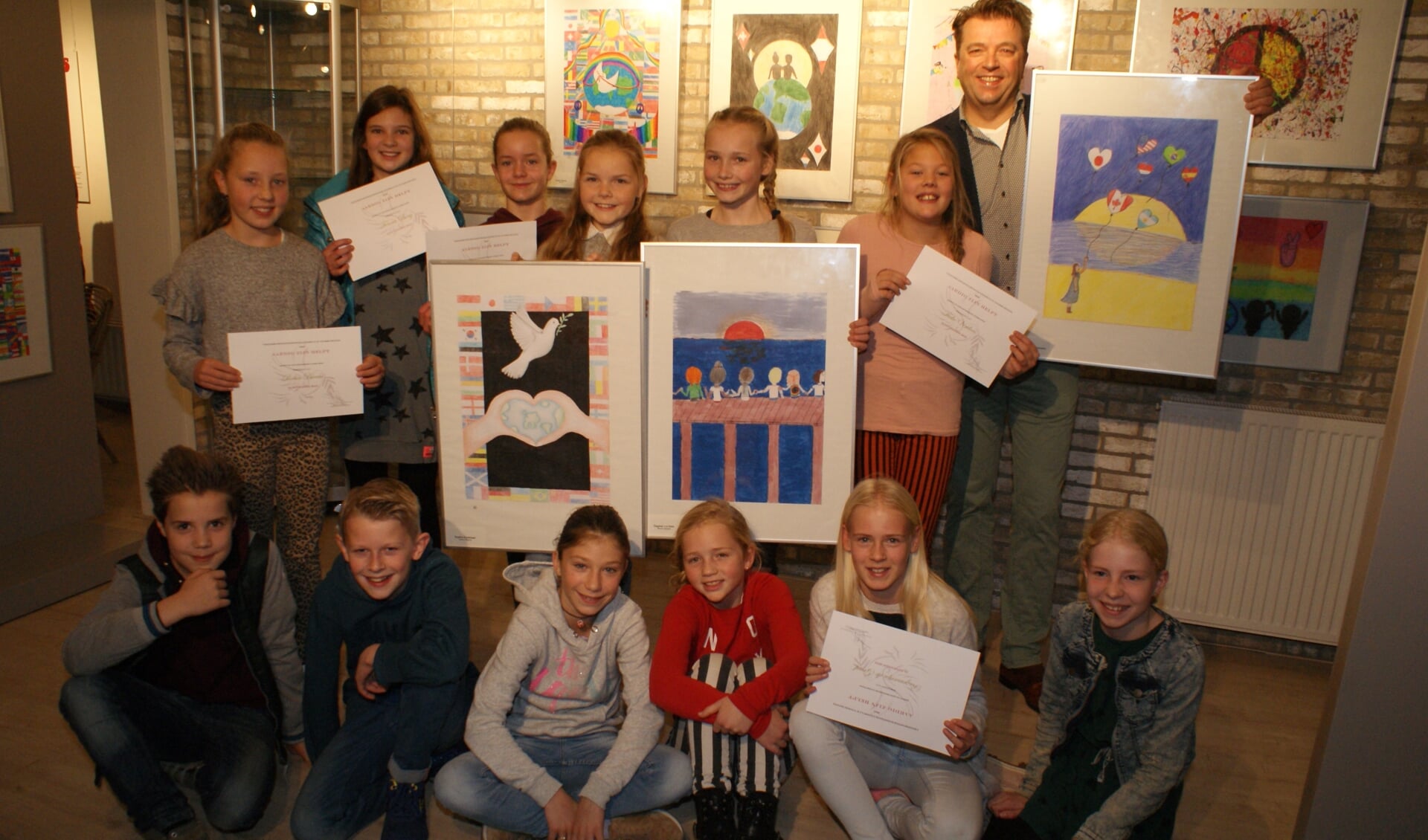 Een aantal winnaars van de Peace Poster wedstrijd met Lions voorzitter Erwin Lunshof. Foto: VSK