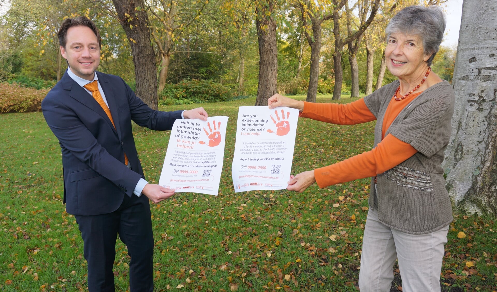 Wethouder Paul de Bruijn neemt van Lineke Stoop de poster Stop Geweld tegen Vrouwen in ontvangst en toont met zijn oranje das zijn betrokkenheid bij deze belangrijke campagne. Foto: Vsk