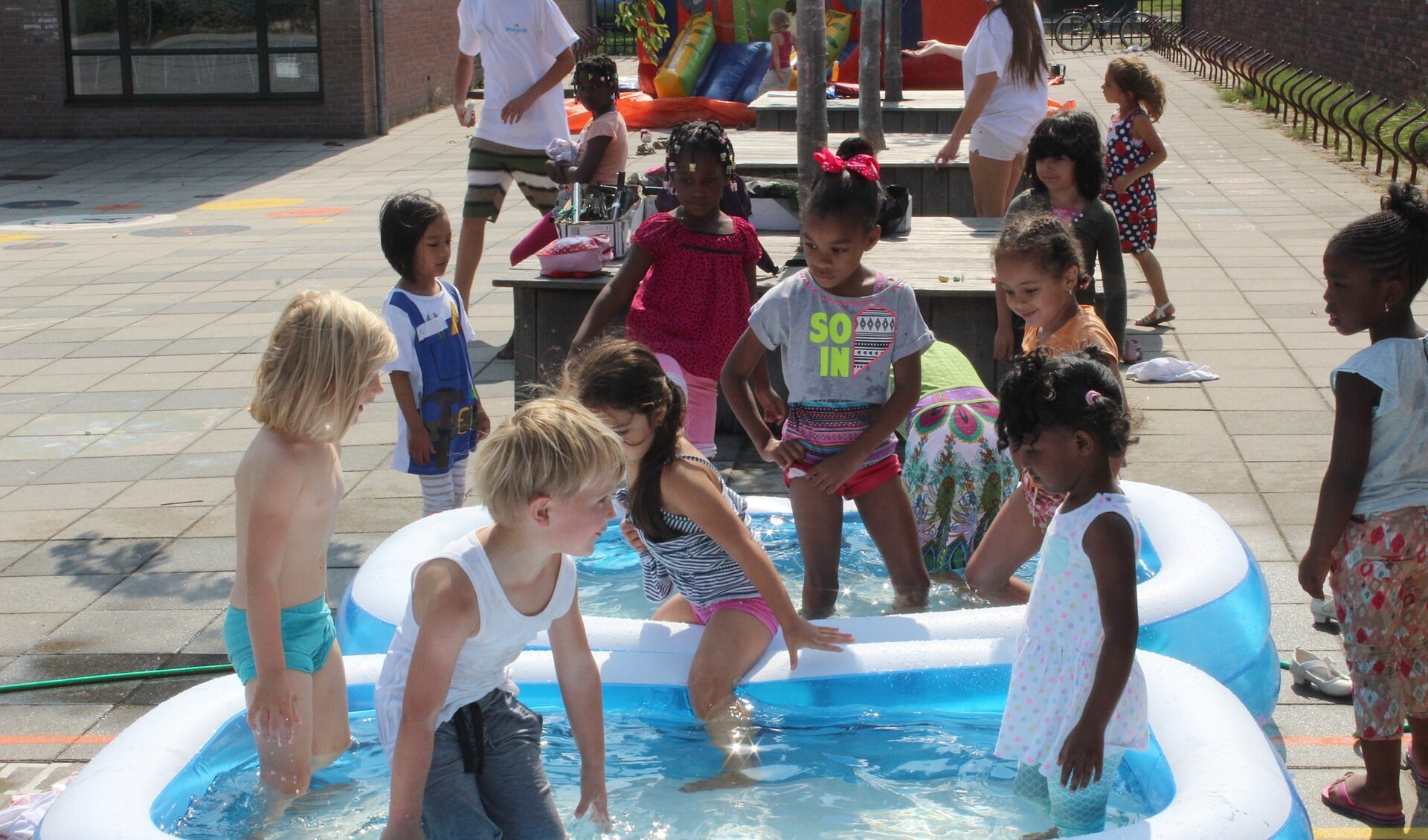 De warmte dreef veel kinderen toch naar de waterbadjes (foto: Dick Janssen).