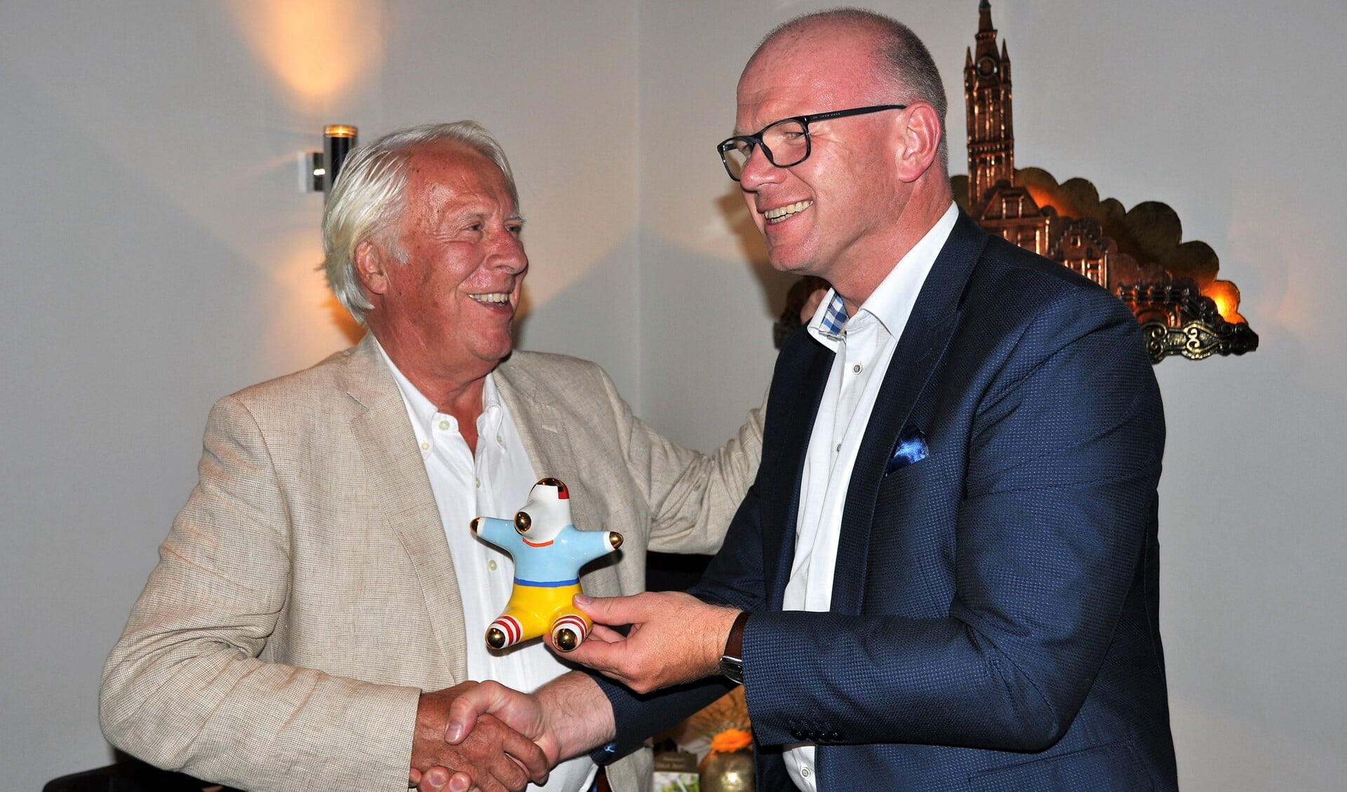 Jan Kok (l.) neemt de gemeentelijke onderscheiding UBU in ontvangst van burgemeester Klaas Tigelaar (foto: Bureau Tigges).