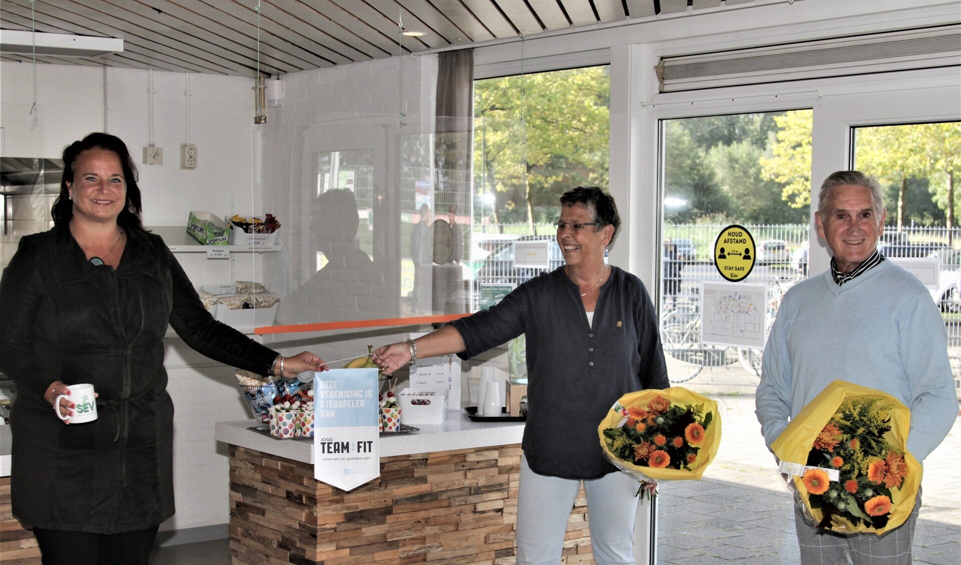 Wethouder Stemerdink overhandigde het vaantje voor de gezonde kantine aan Margriet Asselman en Paul van Rooijen (foto: Rik driessen). 