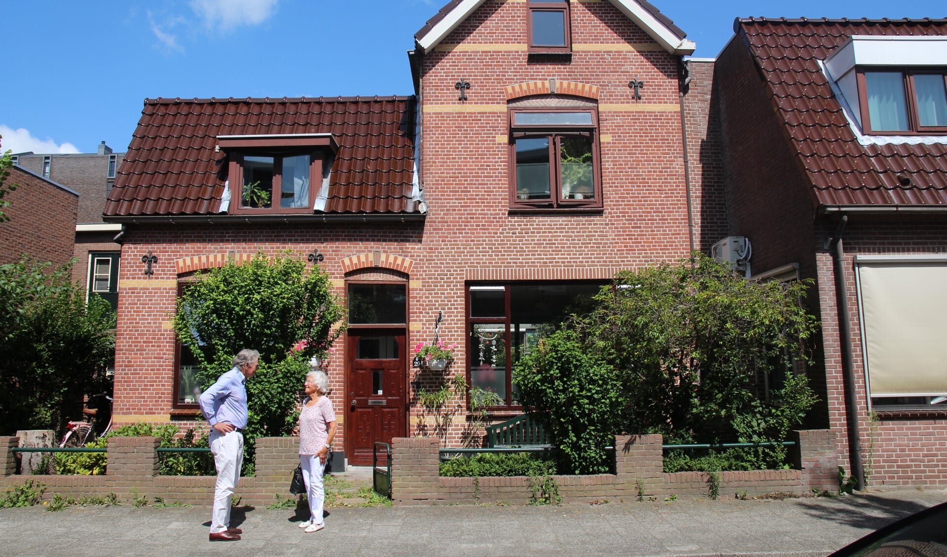 Boudewijn Bolle en Truusje van der Horst bij het huis in de Stationsstraat waar de praktijk van Dokter Bolle gevestigd was en waar de Engelandvaarders zich kwamen melden.