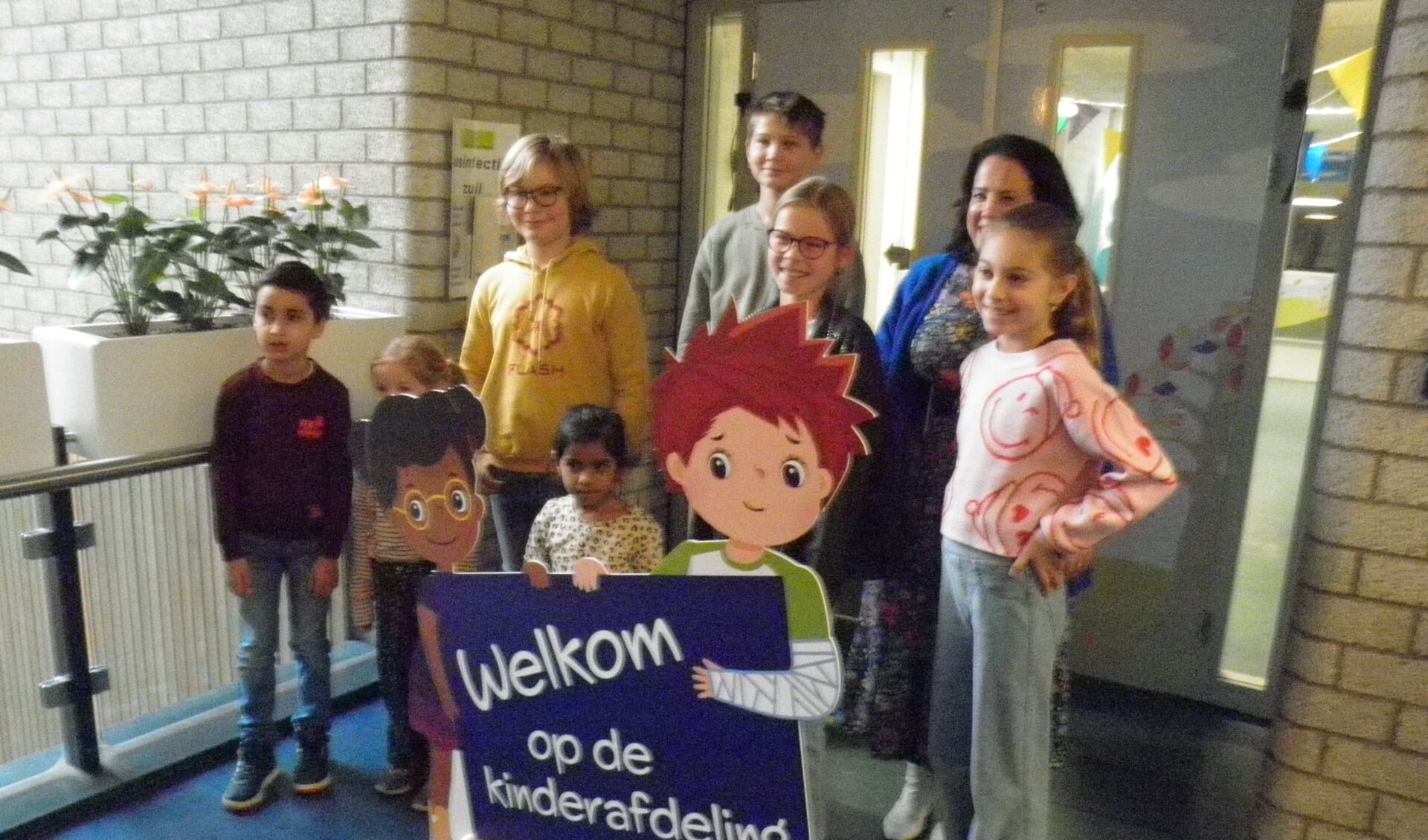Kinderen met pedagogisch medewerker Hannah Heesbeen poseren graag met mascottes Lenn en Leyla. Foto Kees van Rongen