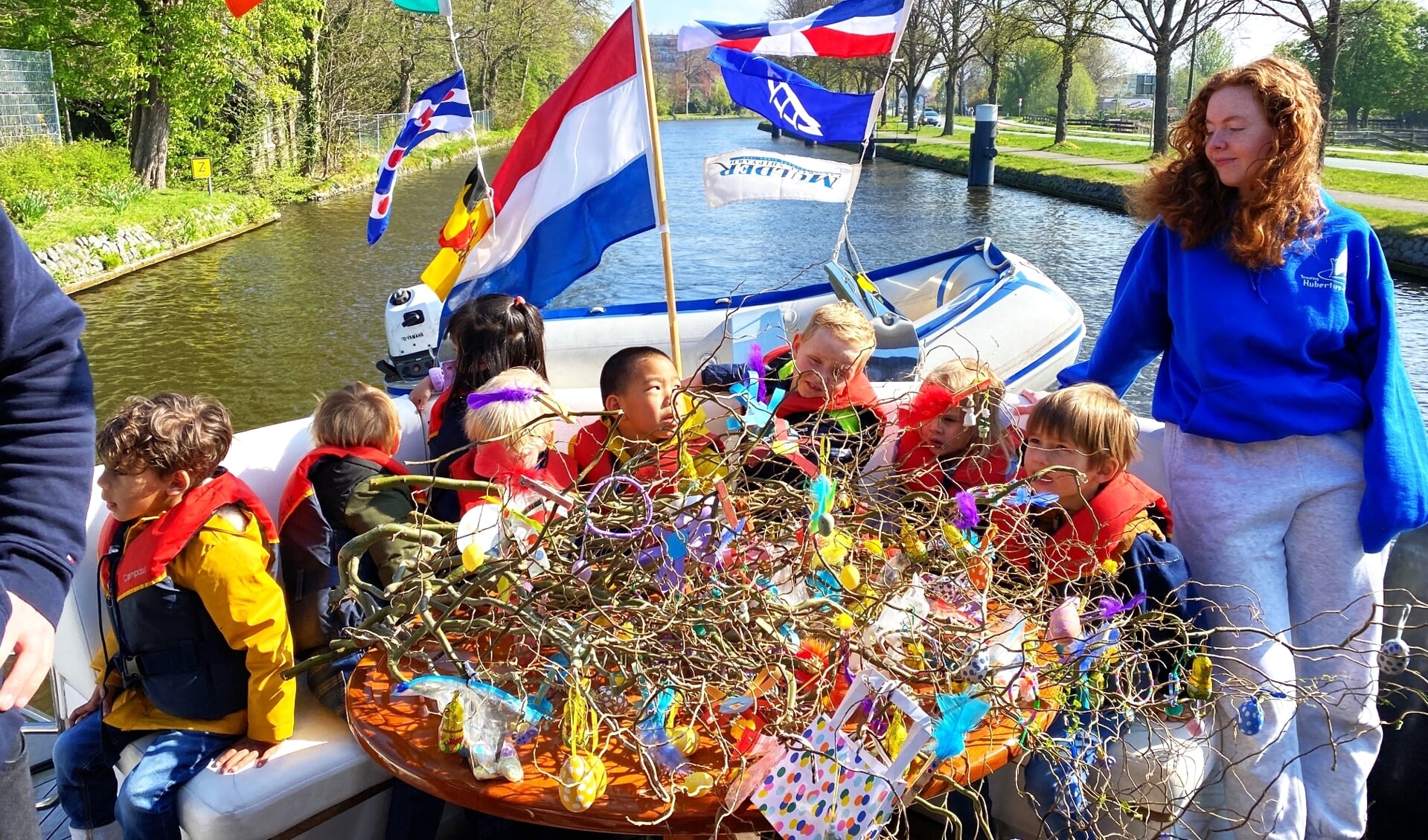 Bevers van Hubertus Brandaan met hun kleurrijk versierde paastakken in de boot op weg naar de Vliethof (foto: pr).