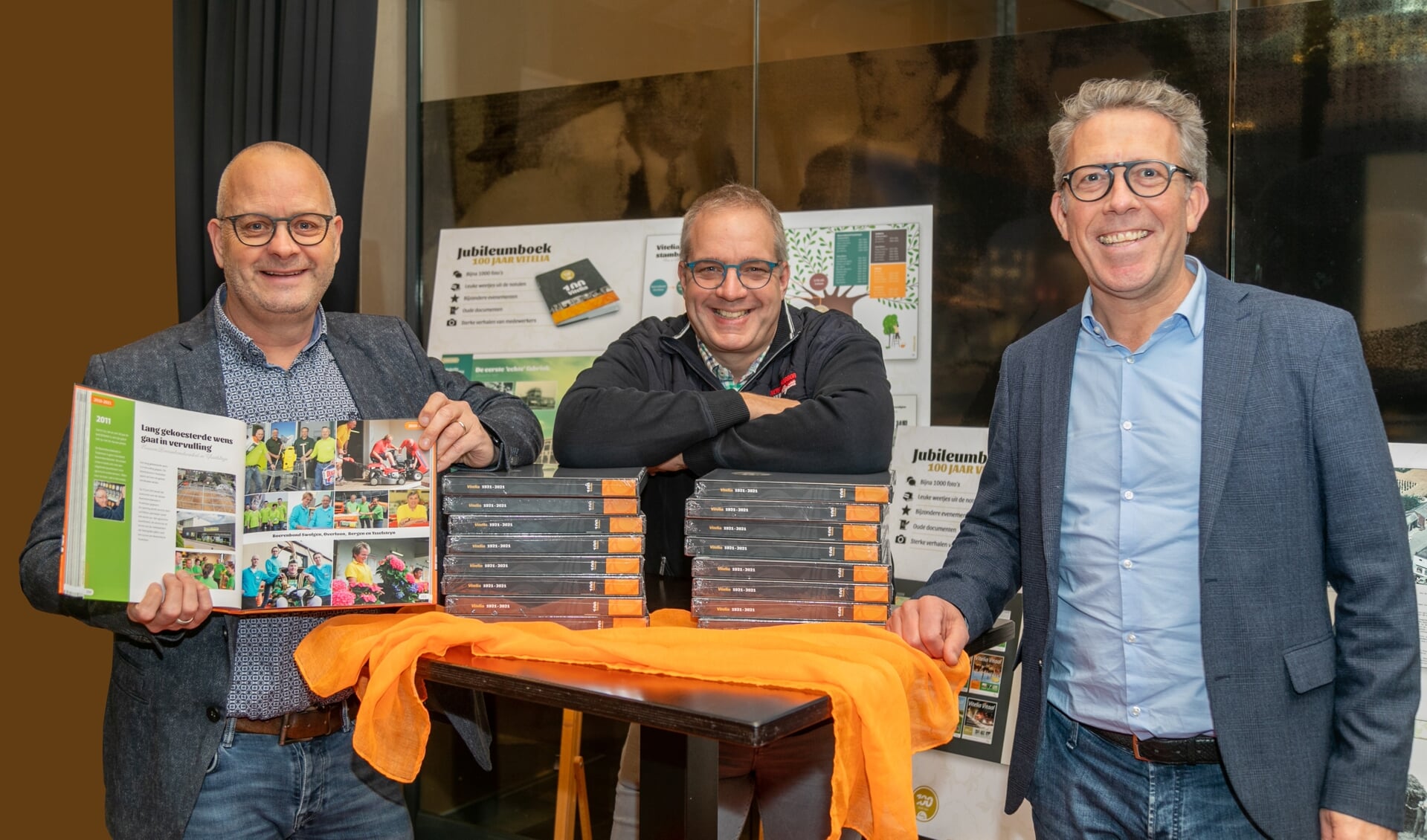 Voorzitter Edwin Michiels (midden), Stefan Kuijpers (links) en Herman Rutten (rechts) tonen vol trots het jubileumboek.