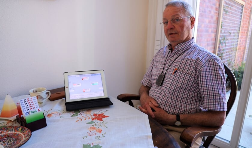 <p>Maarten Houba bridget de laatste maanden online op zijn tablet.</p>