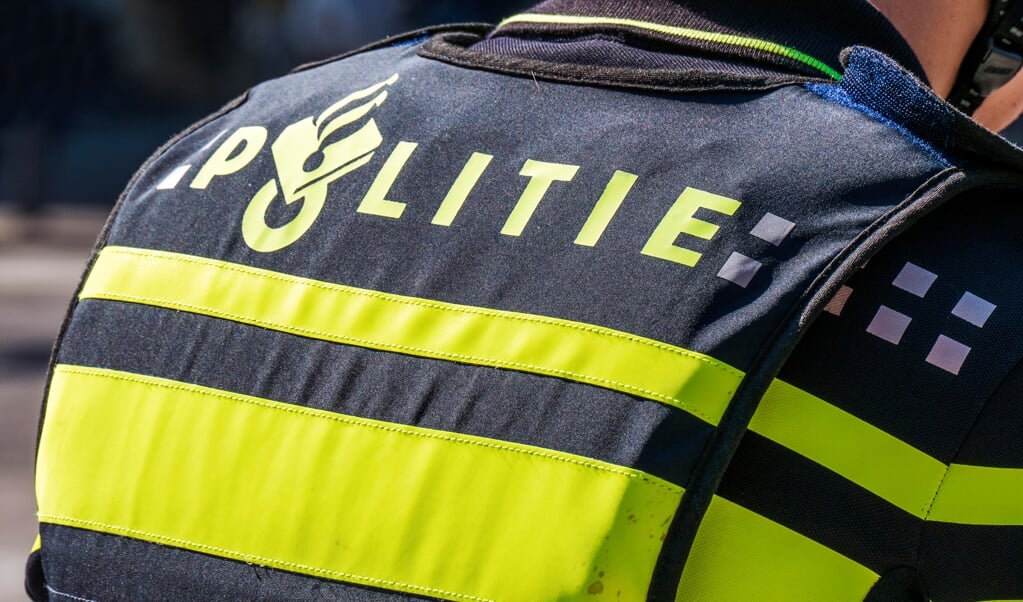 NETHERLANDS - THE HAGUE - SEPTEMBER 11, 2015: Shot of the back of a Dutch police officer's jacket with the word politie in The Hague, near by the government buildings.