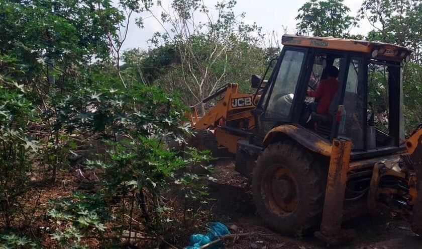 <p>Een bulldozer bewerkt het land waar het crematorium komt.</p>