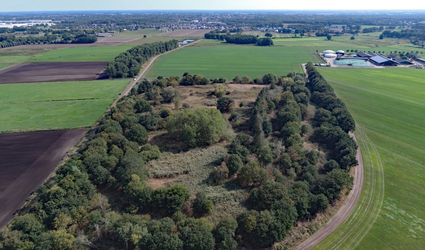 De zes hectare grote voormalige vuilstort Venrays Broek vanuit de lucht, met op de achtergrond de skyline van Venray. 
