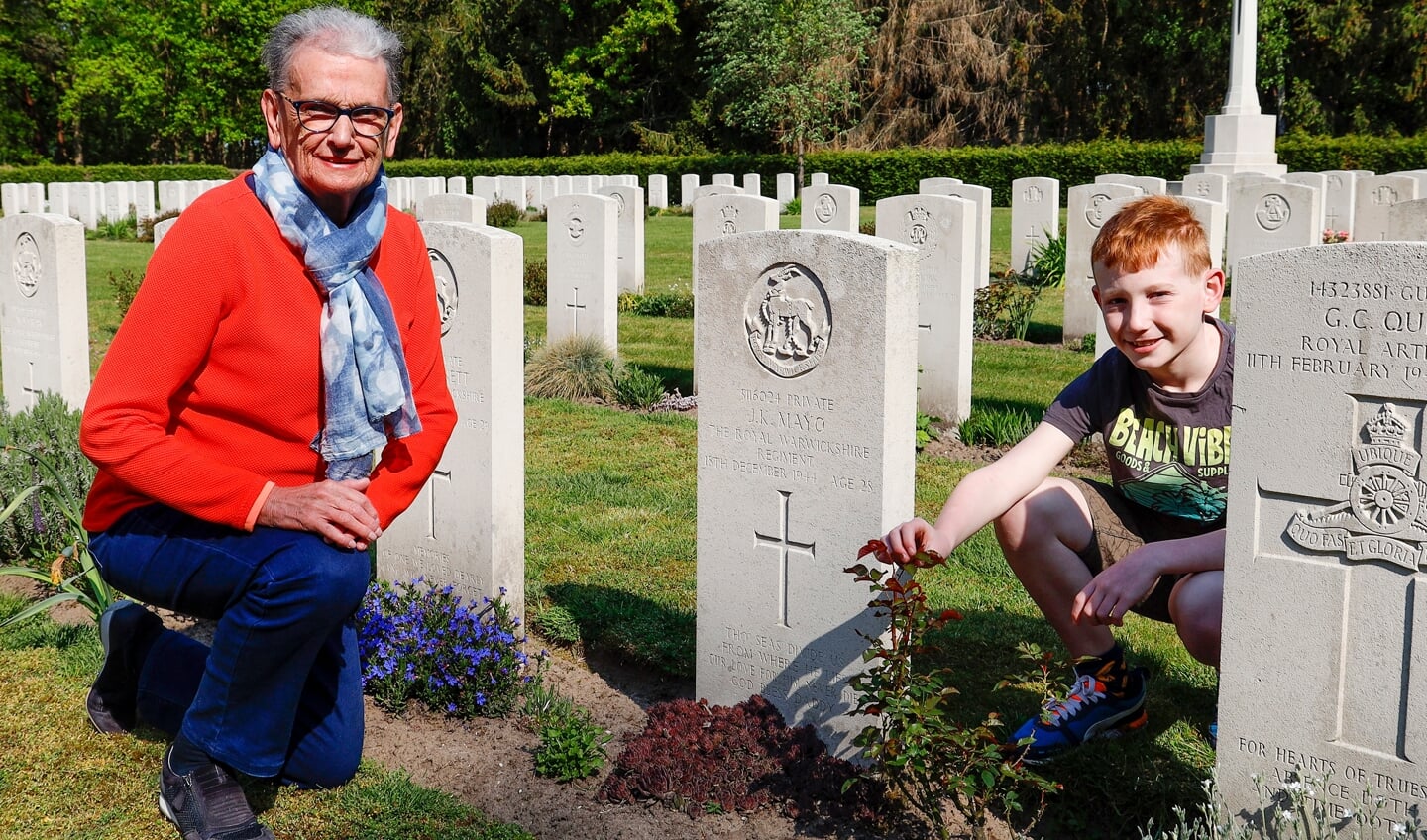 Dorine Pappers-Manders met haar kleinzoon Michiel Klomp bij het graf van de gesneuvelde soldaat John Mayo op het Engelse kerkhof in Venray. 
