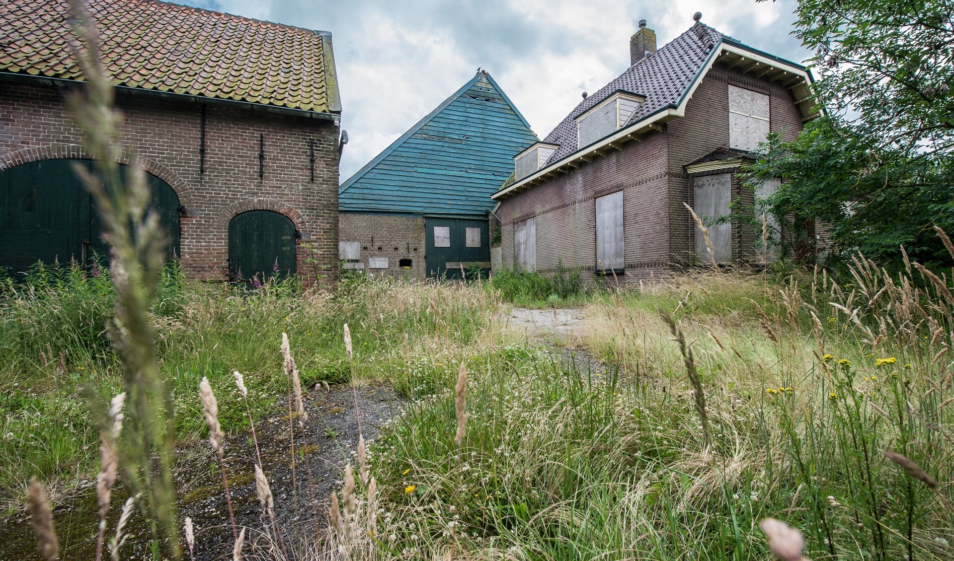 Op de beoogde locatie voor de woningen en appartementen staat een vervallen boerderij.