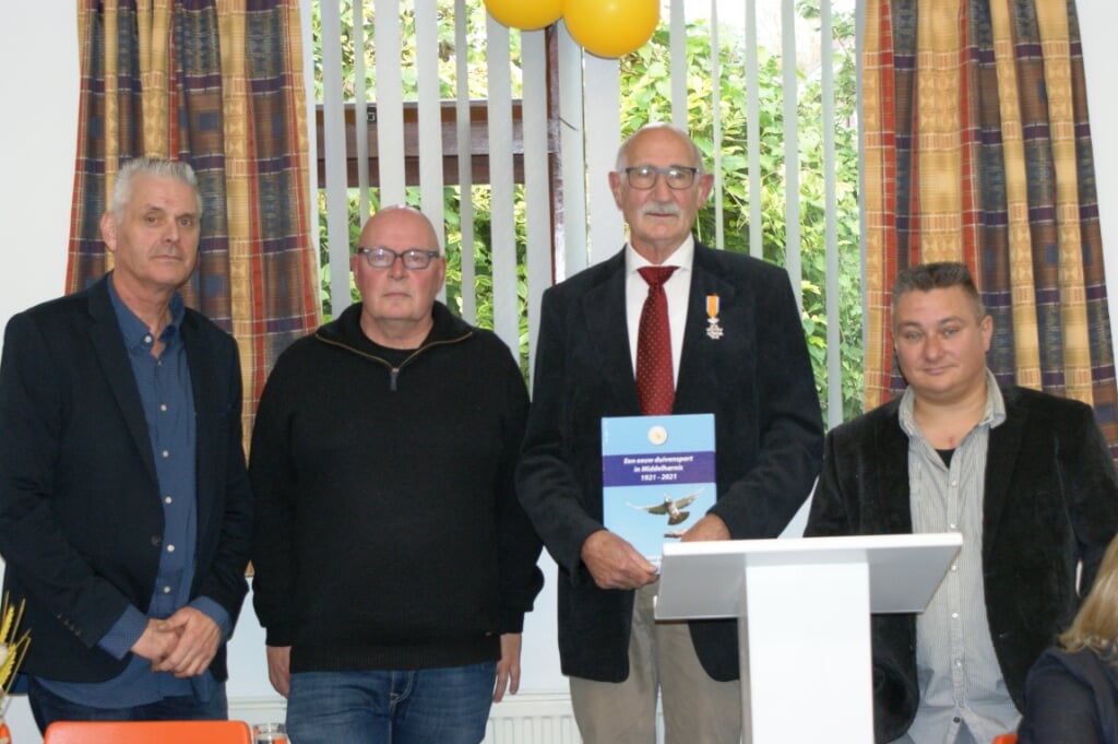 Voorzitter Jaap Jongejan (tweede van rechts) showt het eerste exemplaar van het jubileumboek, geflankeerd door de leden van de Jubileumcommissie David Bakker (links), Jaap Westhoeve en Hans Vroegindeweij (uiterst rechts).