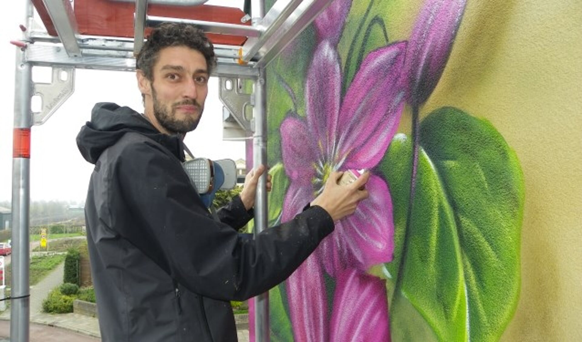 Graffitikunstenaar Joost Zwanenburg fleurt Boskoop op met een schildering van enorme clematisbloemen. Sinds vier jaar woont hij in Amsterdam, maar hij komt gedeeltelijk terug. 