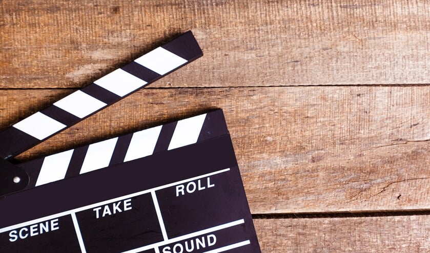 photo of movie clapper on wood