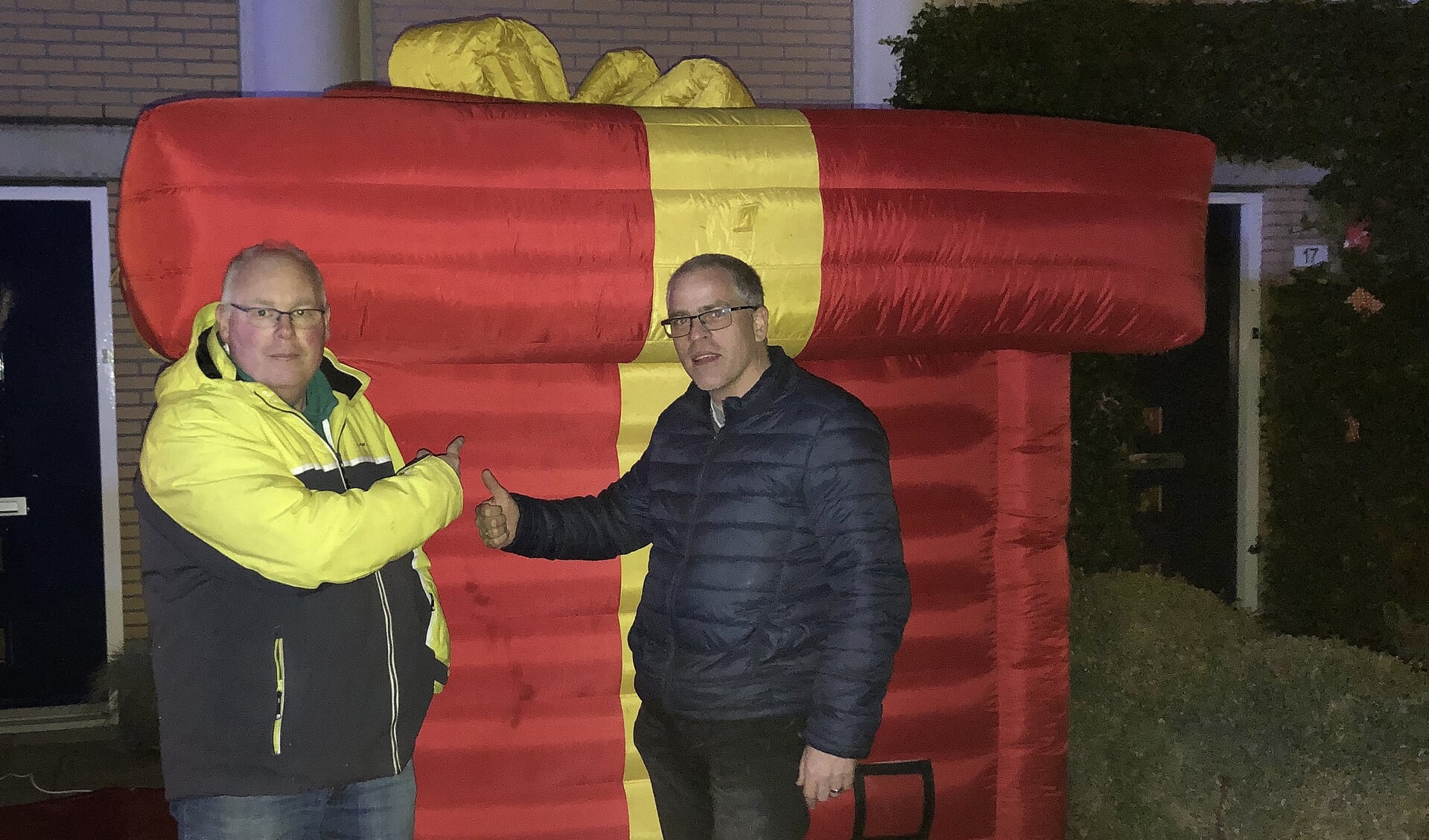 Voorzitter René de Reus, links, krijgt het 'grootste cadeau van Nederland' afgeleverd.... 