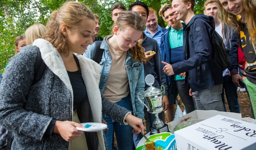 De 2 winnaars Robin Holthuizen en Maya Hendriksen snijden de taart aan.